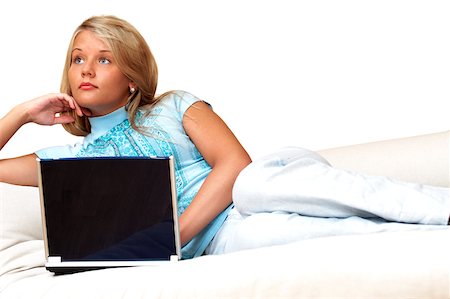Businesswoman reclining in front of a laptop Stock Photo - Premium Royalty-Free, Code: 625-00836402