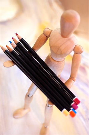 simsearch:625-00836542,k - High angle view of color pencils on a wooden figurine Stock Photo - Premium Royalty-Free, Code: 625-00836559