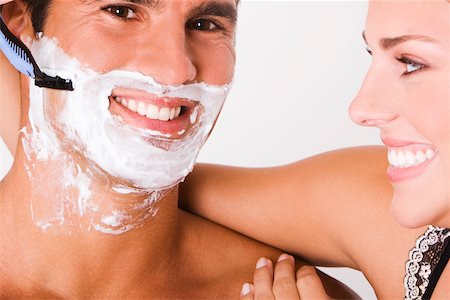 shaving man woman - Close-up of a young woman shaving a mid adult man Stock Photo - Premium Royalty-Free, Code: 625-00837596