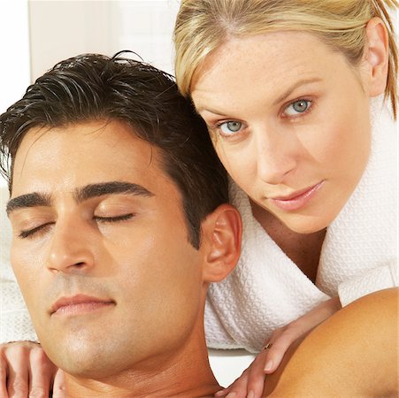 Portrait of a young woman massaging a young man Stock Photo - Premium Royalty-Free, Code: 625-00837630