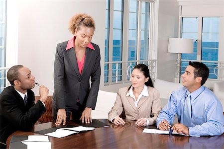 Two businessmen and two businesswomen in a meeting Stock Photo - Premium Royalty-Free, Code: 625-00837871