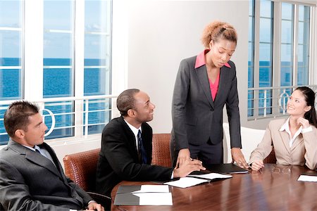 Two businessmen and two businesswomen in a meeting Stock Photo - Premium Royalty-Free, Code: 625-00837872