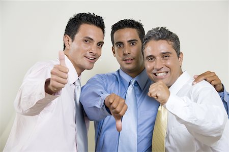 Portrait of three businessmen gesturing thumbs up Stock Photo - Premium Royalty-Free, Code: 625-00837881