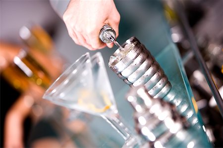 pouring cocktail shaker into glass - Close-up of a person's hand preparing a cocktail Stock Photo - Premium Royalty-Free, Code: 625-00837966