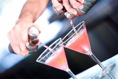 pouring cocktail shaker into glass - Close-up of a person's hand preparing a cocktail Stock Photo - Premium Royalty-Free, Code: 625-00837967