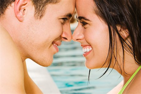 simsearch:625-01092421,k - Side profile of a young couple looking at each other at the poolside Stock Photo - Premium Royalty-Free, Code: 625-00838240