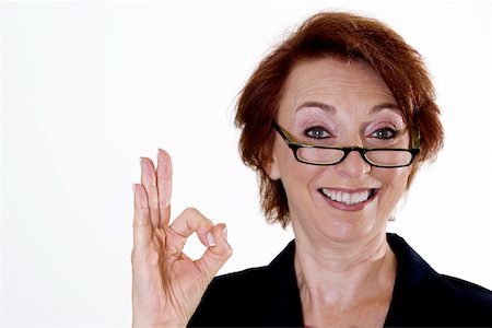 perfect white teeth - Portrait of a businesswoman showing an ok sign Stock Photo - Premium Royalty-Free, Code: 625-00838409