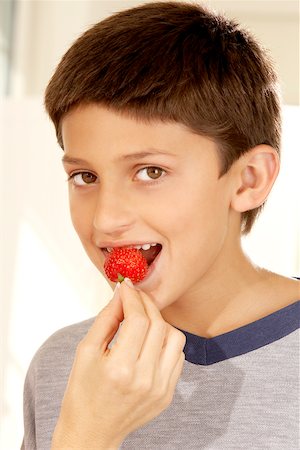 preteens fingering - Close-up of a woman's hand feeding a boy a strawberry Stock Photo - Premium Royalty-Free, Code: 625-00838604