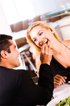 schoolchild eat - Close-up of a mid adult man feeding a young woman a strawberry Stock Photo - Premium Royalty-Free, Code: 625-00838959