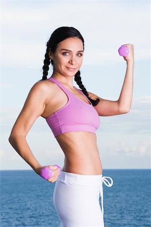 simsearch:625-00901737,k - Portrait of a young woman exercising with dumbbells Stock Photo - Premium Royalty-Free, Code: 625-00839004