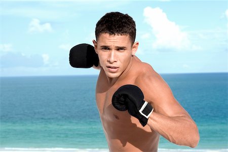 exercise black people water - Portrait of a young man wearing boxing gloves Stock Photo - Premium Royalty-Free, Code: 625-00839023