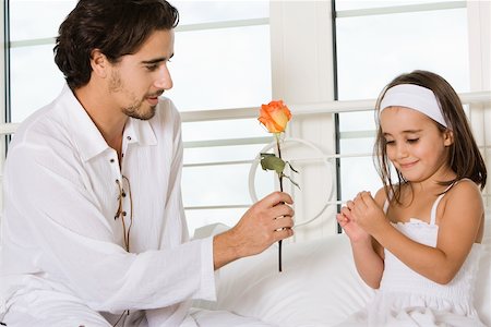 Close-up of a father giving his daughter a rose Stock Photo - Premium Royalty-Free, Code: 625-00839227