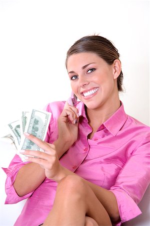 simsearch:625-01095402,k - Portrait of a young woman talking on a mobile phone and holding US paper currency Foto de stock - Sin royalties Premium, Código: 625-00839355