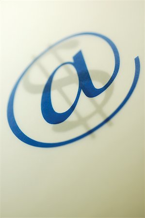 speed with computer - Close-up of an 'at' symbol over a dollar sign Stock Photo - Premium Royalty-Free, Code: 625-00839923