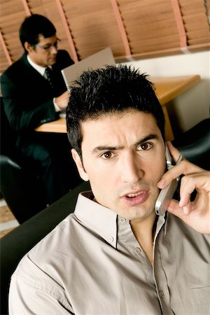High angle view of two young businessmen working in an office Foto de stock - Sin royalties Premium, Código: 625-00848857