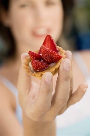 Young woman holding a cupcake Stock Photo - Premium Royalty-Free, Code: 625-00849180