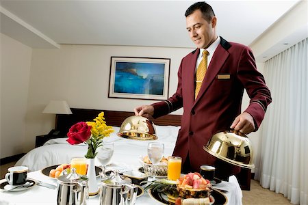 room service food - Waiter serving food Stock Photo - Premium Royalty-Free, Code: 625-00849383