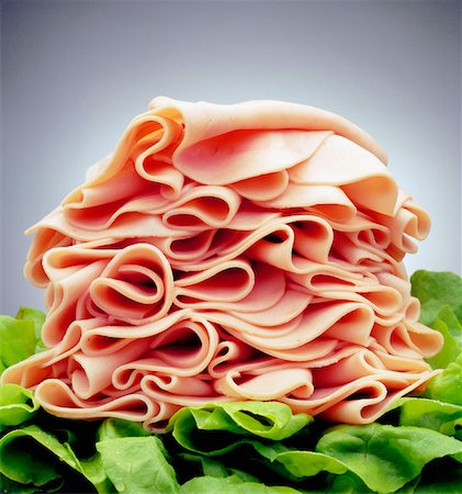 slice ham - Close-up of a heap of ham on lettuce leaves Stock Photo - Premium Royalty-Free, Code: 625-00849858