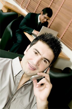 simsearch:693-03307925,k - High angle view of two businessmen working in an office Fotografie stock - Premium Royalty-Free, Codice: 625-00849879