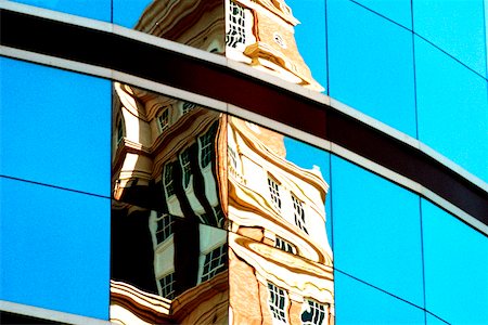 Reflection of a building on the glass front of an office building Stock Photo - Premium Royalty-Free, Code: 625-00840645