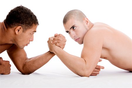 Side profile of two young men arm wrestling Stock Photo - Premium Royalty-Free, Code: 625-00841200