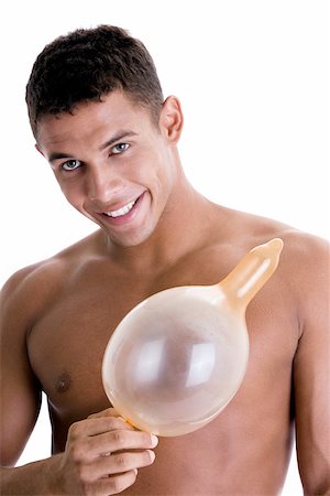 Portrait of a young man holding a blown condom Stock Photo - Premium Royalty-Free, Code: 625-00841285