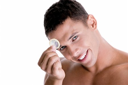 Portrait of a young man holding a condom Stock Photo - Premium Royalty-Free, Code: 625-00841297