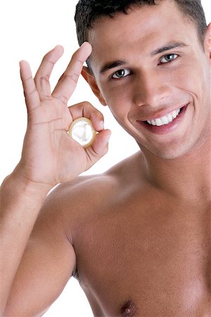 simsearch:625-00851085,k - Portrait of a young man holding a condom Foto de stock - Royalty Free Premium, Número: 625-00841291