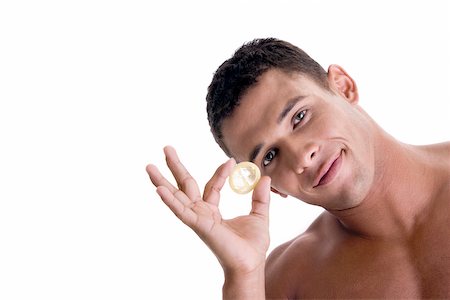 simsearch:625-00851085,k - Portrait of a young man holding a condom Foto de stock - Royalty Free Premium, Número: 625-00841292
