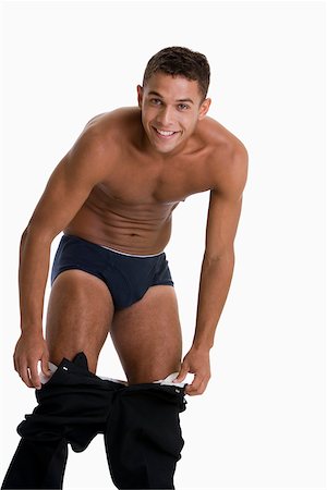 Man taking off underpants Stock Photos - Page 1 : Masterfile