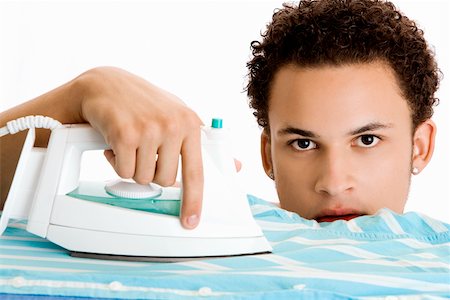 simsearch:625-00841323,k - Portrait of a young man ironing his shirt Stock Photo - Premium Royalty-Free, Code: 625-00841338