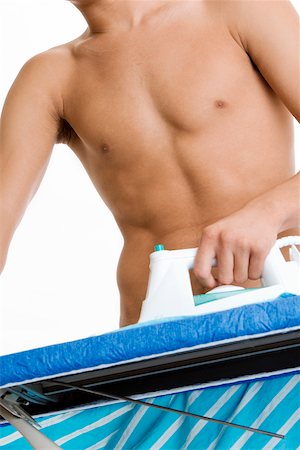 simsearch:625-00841323,k - Mid section view of a young man ironing his shirt Stock Photo - Premium Royalty-Free, Code: 625-00841341