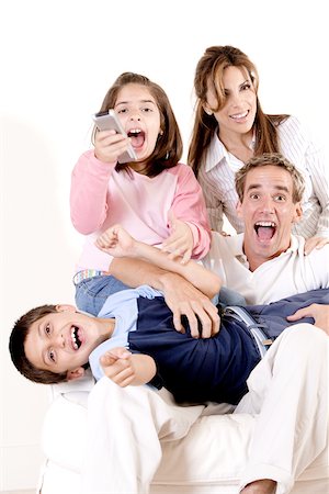 simsearch:693-03564397,k - Portrait of parents watching television with their son and daughter Foto de stock - Sin royalties Premium, Código: 625-00841356