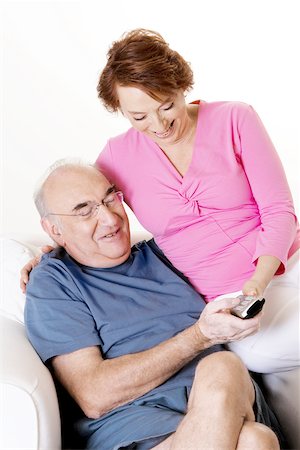 Close-up of a senior couple looking at a remote control Stock Photo - Premium Royalty-Free, Code: 625-00841587