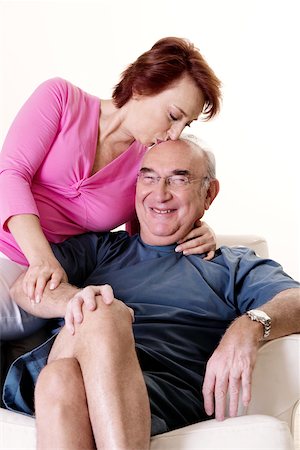 elderly woman seated in armchair - Close-up of a senior woman kissing a senior man Stock Photo - Premium Royalty-Free, Code: 625-00841597