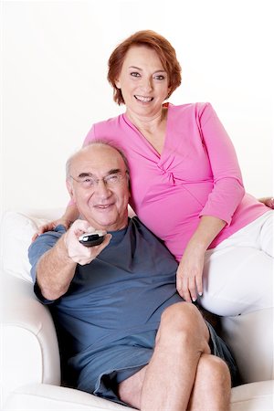 elderly woman seated in armchair - Portrait of a senior couple watching television Stock Photo - Premium Royalty-Free, Code: 625-00841591