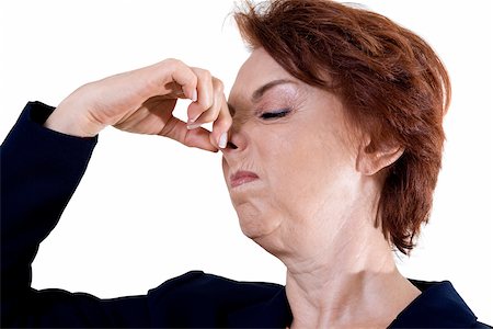 Close-up of a businesswoman holding her nose Stock Photo - Premium Royalty-Free, Code: 625-00841646