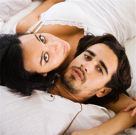 double bedroom - Portrait of a young couple lying on the bed Stock Photo - Premium Royalty-Free, Code: 625-00842341