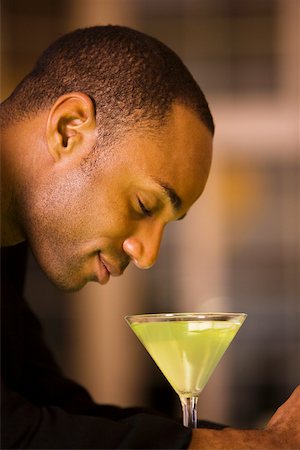 Side profile of a businessman with a glass of martini Stock Photo - Premium Royalty-Free, Code: 625-00842643