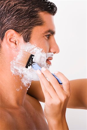 shaving man woman - Close-up of a woman's hand shaving a mid adult man Stock Photo - Premium Royalty-Free, Code: 625-00842725