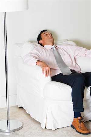 Businessman sleeping in an armchair Stock Photo - Premium Royalty-Free, Code: 625-00850072