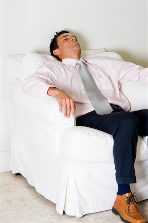 Businessman sleeping in an armchair Stock Photo - Premium Royalty-Free, Code: 625-00850149
