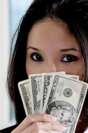Portrait of a businesswoman holding American dollar bills Fotografie stock - Premium Royalty-Free, Codice: 625-00850286