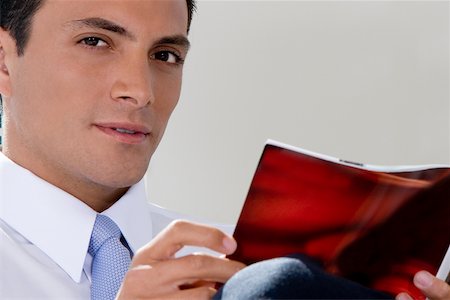 simsearch:625-01096766,k - Portrait of a businessman holding a magazine Stock Photo - Premium Royalty-Free, Code: 625-00850282