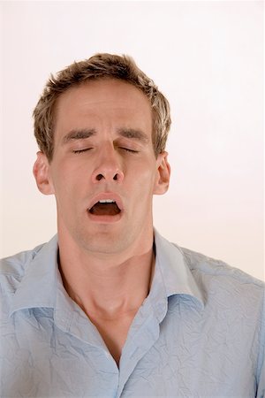 someone about to sneeze - Close-up of a young man yawning Stock Photo - Premium Royalty-Free, Code: 625-00850317