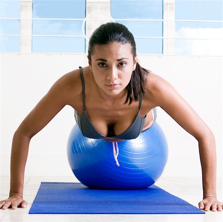 simsearch:625-00901737,k - Portrait of a young woman exercising with a fitness ball Stock Photo - Premium Royalty-Free, Code: 625-00850327