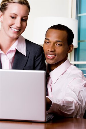 Close-up of a businessman and a businesswoman using a laptop Stock Photo - Premium Royalty-Free, Code: 625-00850388