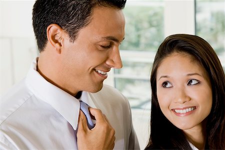 simsearch:625-00850993,k - Close-up of a businessman and a businesswoman smiling Stock Photo - Premium Royalty-Free, Code: 625-00850392