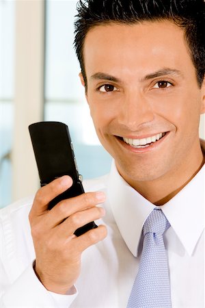 simsearch:625-02266709,k - Portrait of a businessman holding a mobile phone Foto de stock - Sin royalties Premium, Código: 625-00850552