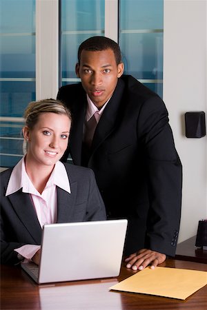 simsearch:625-00851478,k - Portrait of a businessman and a businesswoman in front of a laptop Stock Photo - Premium Royalty-Free, Code: 625-00850685